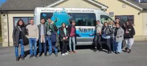 Students standing in front of NBTI bus